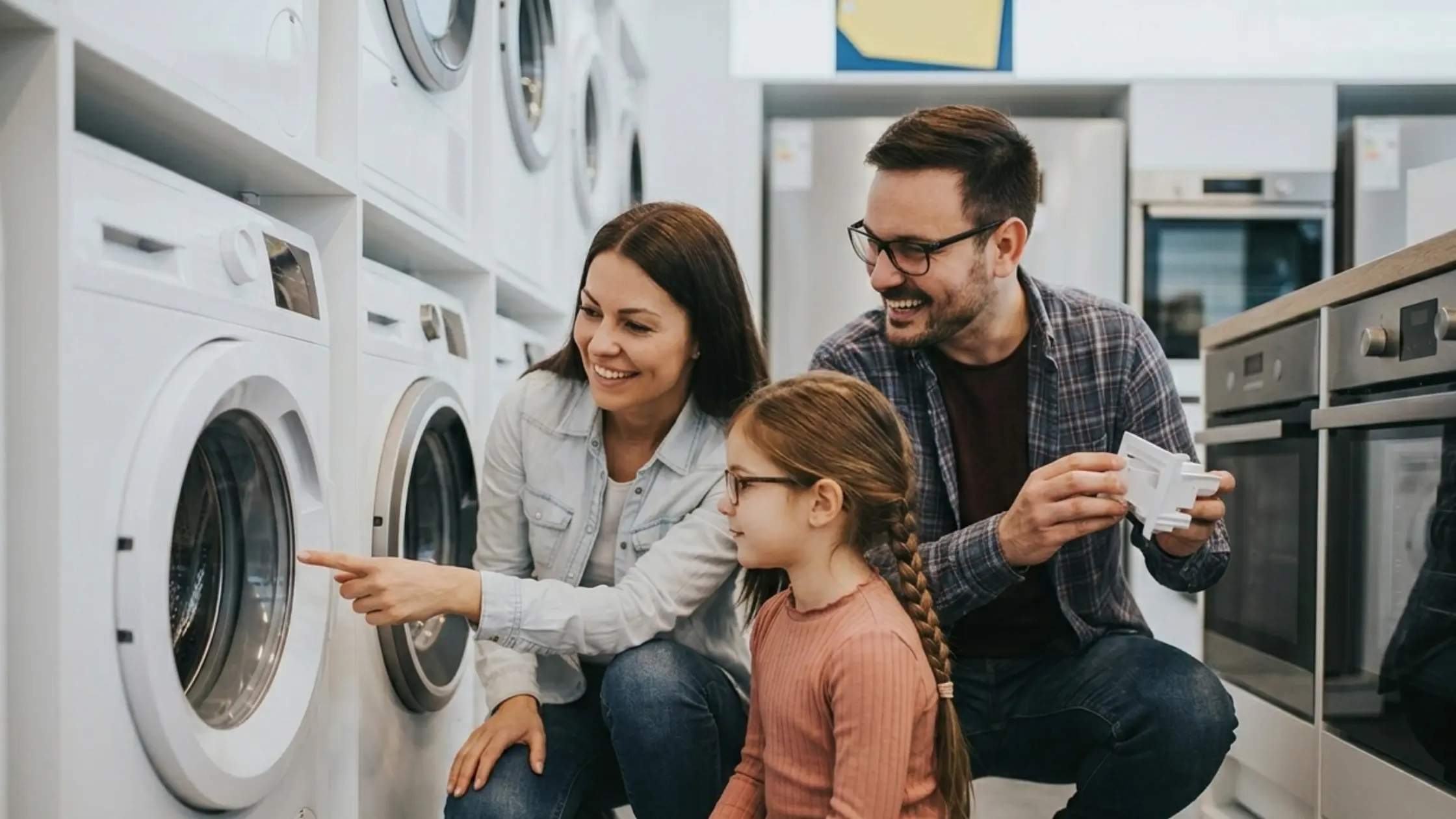 A family is seeing a user washing machine by applying used appliance guide knowledge