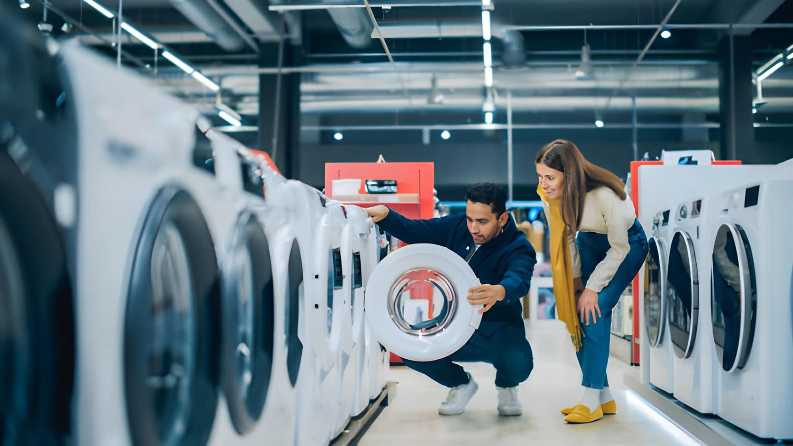 A boy and girl is seeing a Front load washing machine