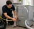 City Appliances technician connecting a gas dryer in a Sacramento laundry room