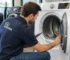 City Appliances technician inspecting the drum and door seal of a used dryer before purchase in Sacramento, California.